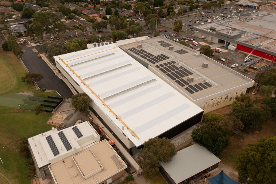 birds eye view of sportlink with  solar panels on roof of older section